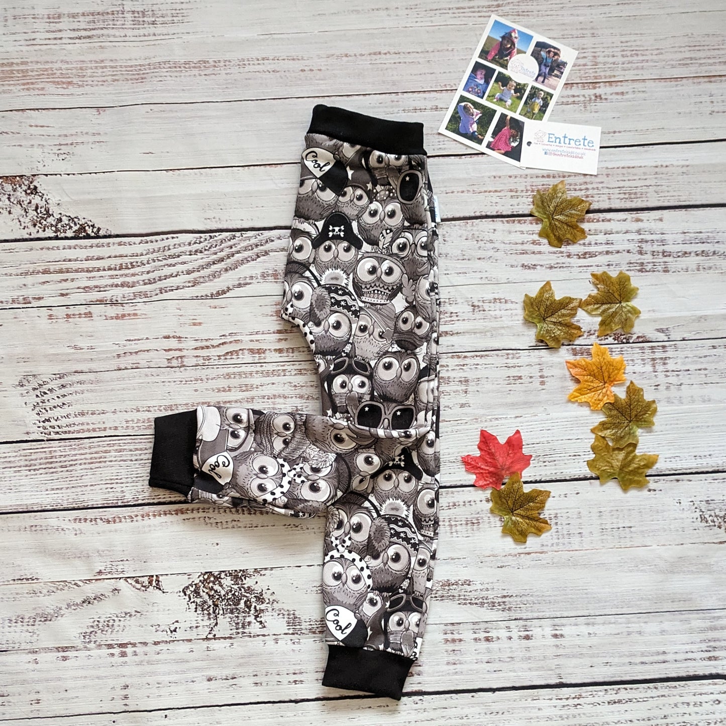 Fun, black and white cartoon owls harem joggers. Handmade using monochrome owls cotton sweatshirt fleece and black cotton ribbing. Shown folded.