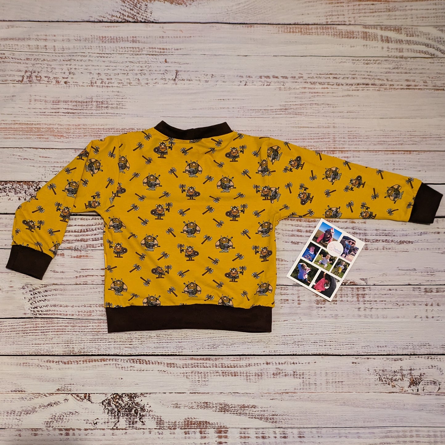 The fun mustard Vikings and chocolate unisex kids sweatshirt. Handmade using mustard Vikings cotton jersey and chocolate cotton ribbing. Shown from the back.