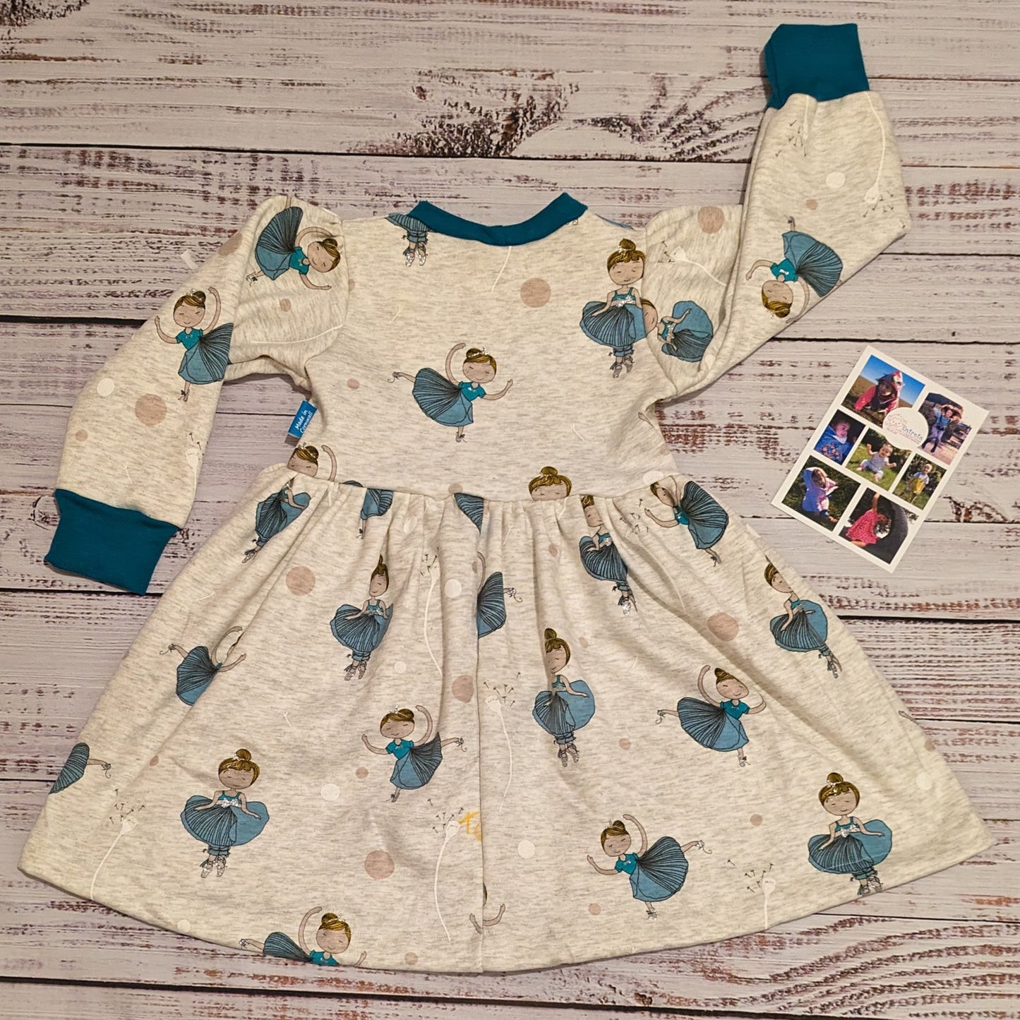 The warm and comfy light grey ballerinas winter dress. Handmade using light grey ballerinas cotton sweatshirt fleece and teal cotton ribbing. Shown from the rear.