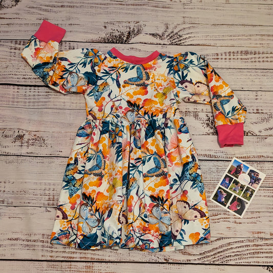 The warm and comfy winter dress, handmade using the gorgeously vibrant butterflies cotton French terry and fuchsia cotton ribbing.