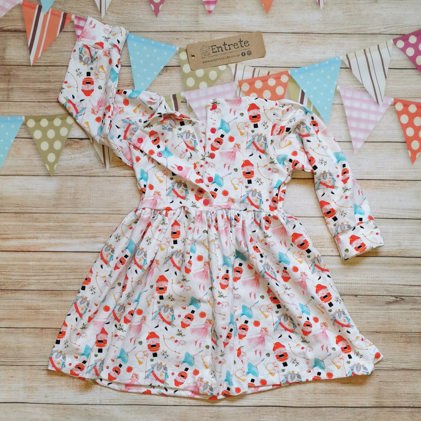 Girls Christmas dress, handmade using the beautiful white nutcracker cotton jersey. Rear view showing the popper opening for sizes over 9-12 months, baby sizes have poppers the length of the dress for easy changing.