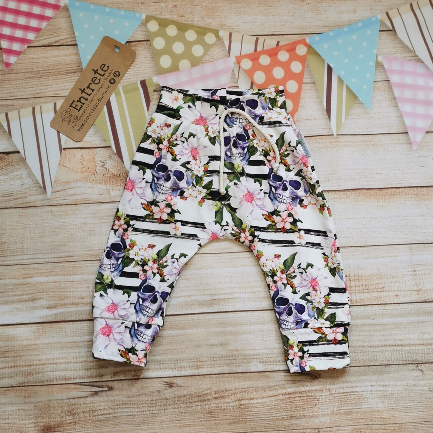 Front view of the gorgeously gothic skulls and flowers cotton jersey harem joggers.