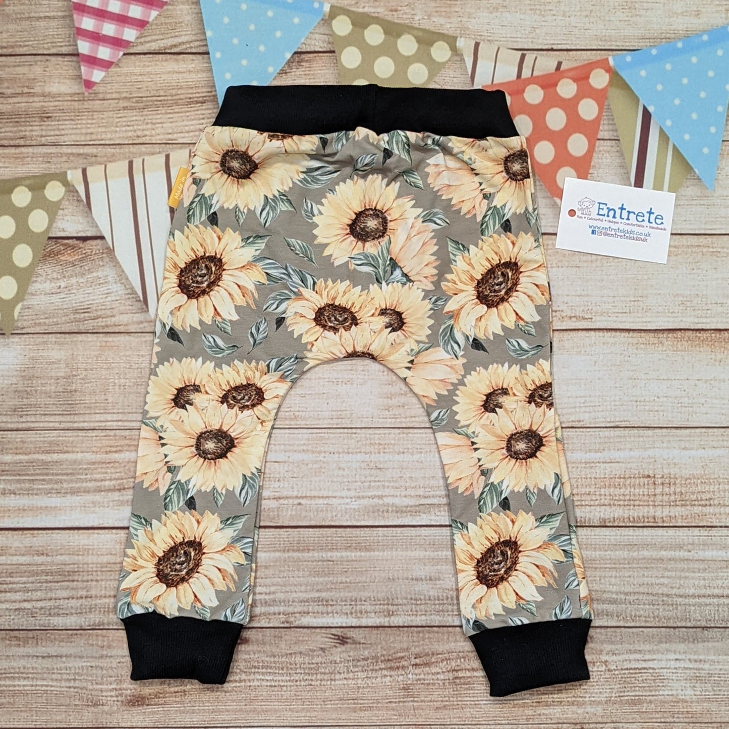 Pretty sunflowers harem joggers, handmade using sunflowers cotton French terry and black cotton ribbing. Shown from the rear.