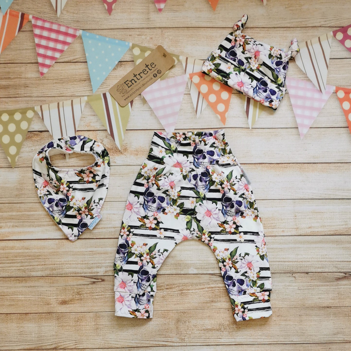 Soft, comfortable harem pants with a non-elasticated waistband, perfect for younger children. Handmade using the gorgeously gothic skulls and flowers cotton jersey. Shown as a gift set with matching bamboo bib and tie top hat.