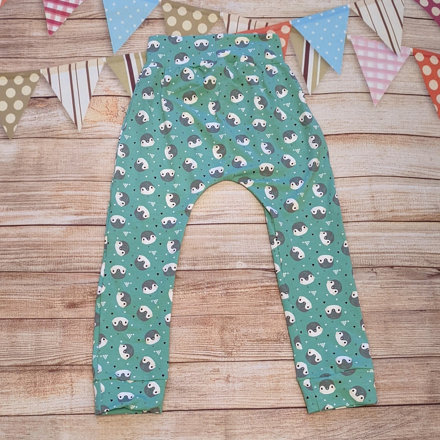 Adorable and ethical, organic mint penguins harem joggers. Handmade using mint penguins organic cotton jersey. Shown from the rear.