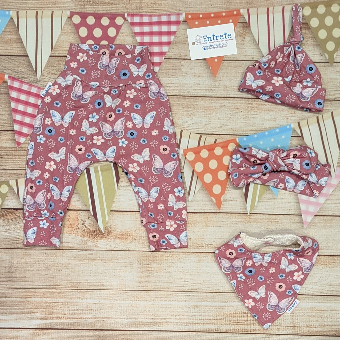 Pretty pink butterflies organic harem pants. Handmade using organic pink butterflies cotton jersey. Shown with matching tie top hat, headband and bamboo bib.
