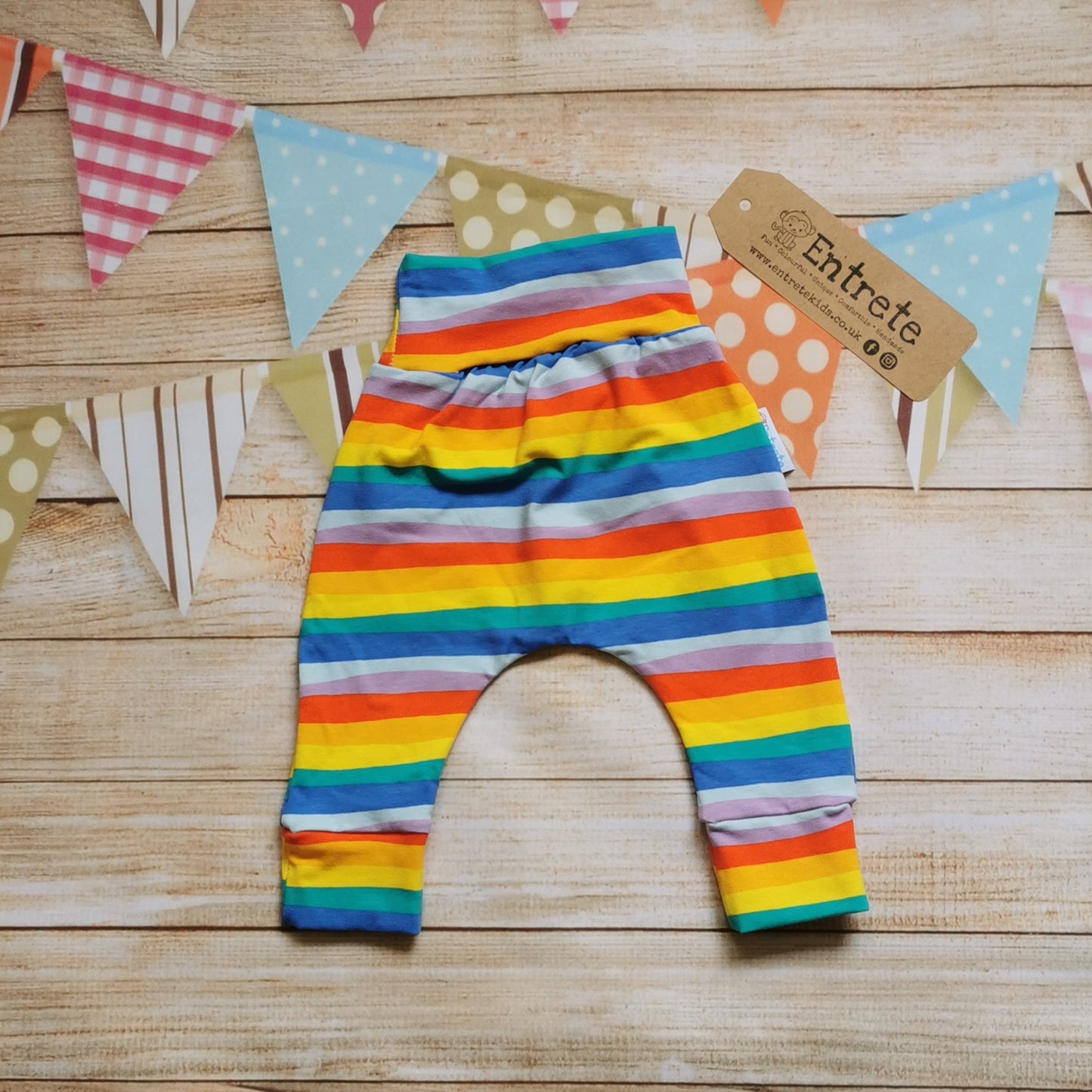 Rear of colourful red rainbow striped harem pants. With rollable ankle cuffs, dropped crotch and non-elasticated waist.