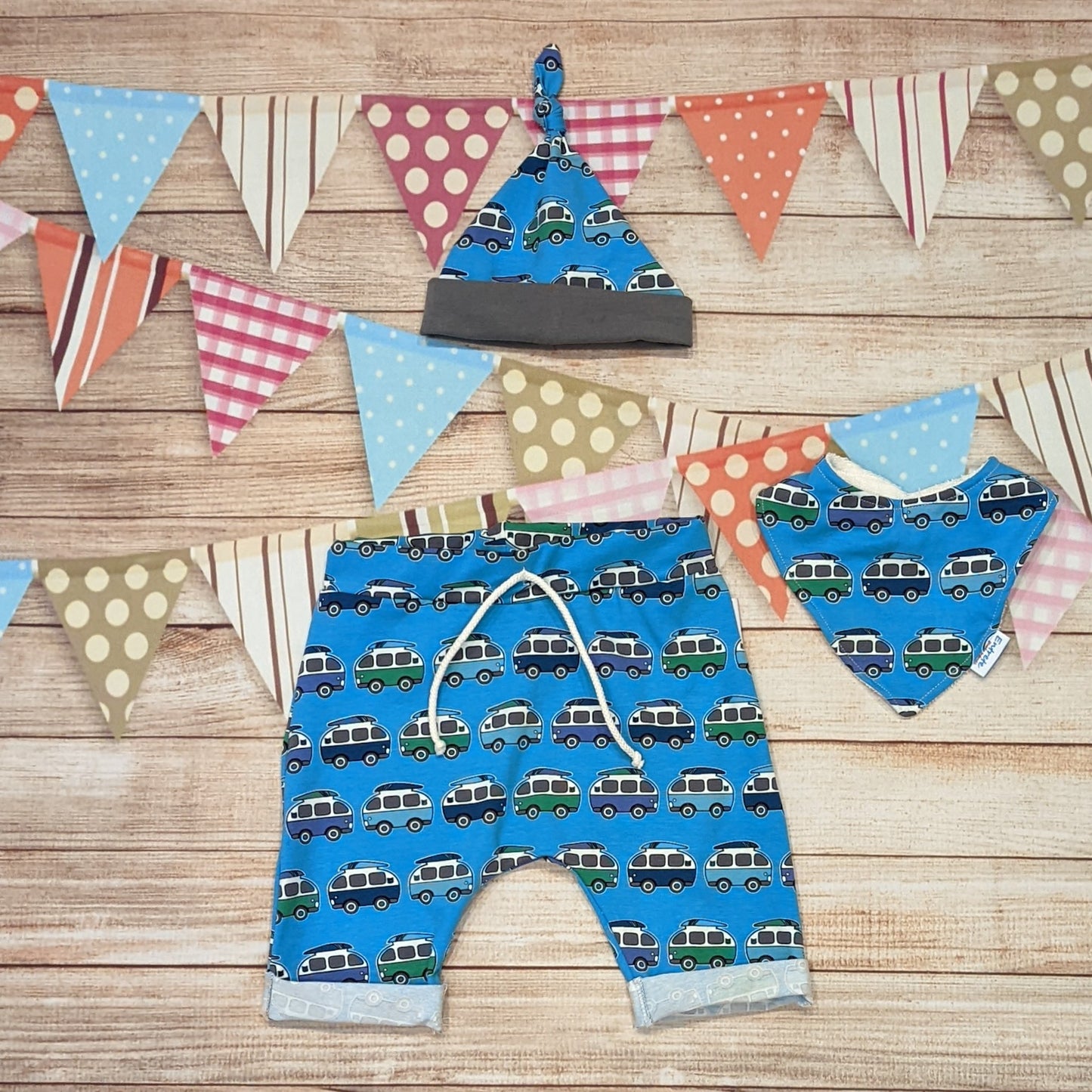 The epic blue surf camper Harem shorts, handmade using blue surf campervan cotton jersey. Shown with a matching tie top hat and bamboo bib.