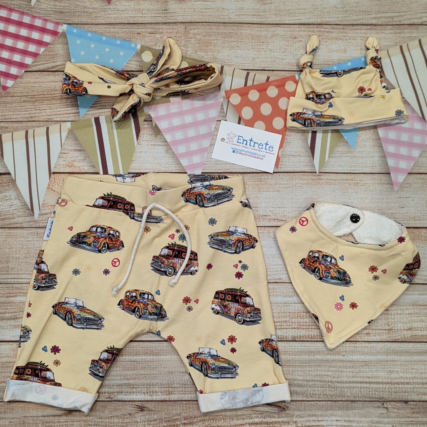 The fun retro hippie cars harem shorts, handmade using light yellow hippie cars cotton jersey. Shown with matching bamboo bib, tie top hat and headband.