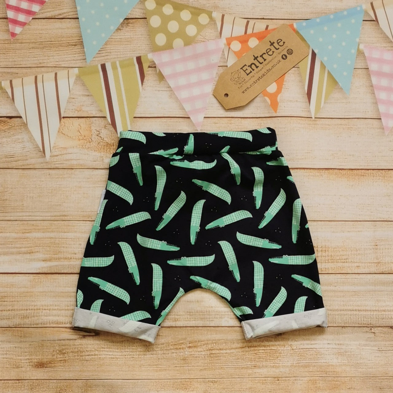 Rear view of fun navy crocodiles harem shorts.
