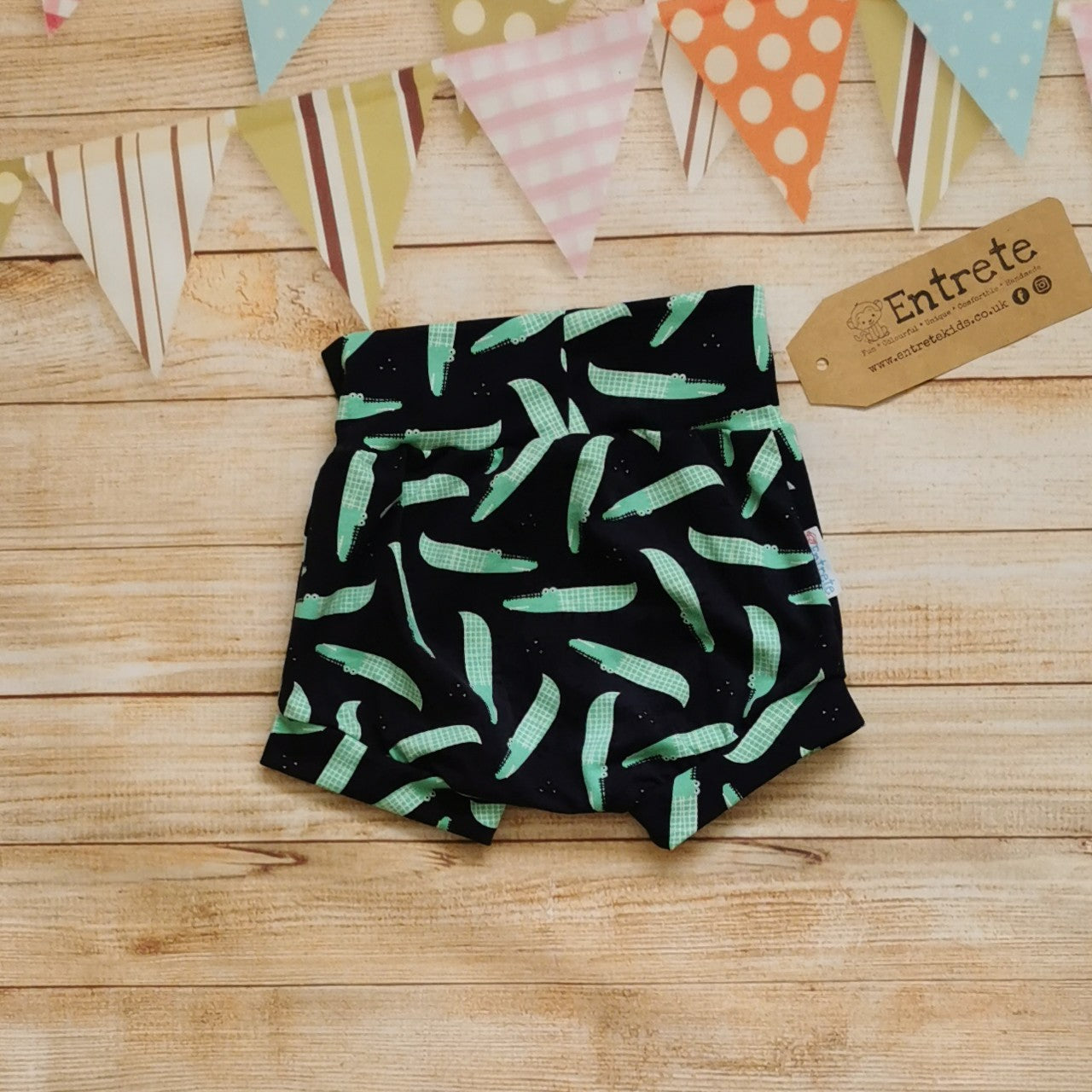 Rear view of fun navy crocodiles child and baby shorts.