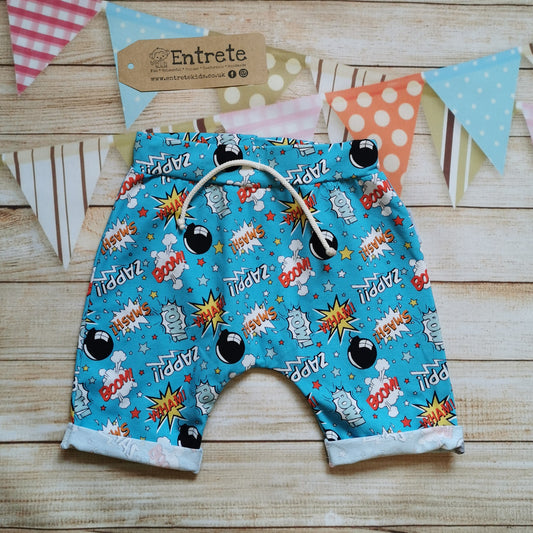 Fun and colourful harem shorts, handmade from turquoise boom pow wow cotton jersey. Featuring elasticated waist, rolled ends and lowered crotch.