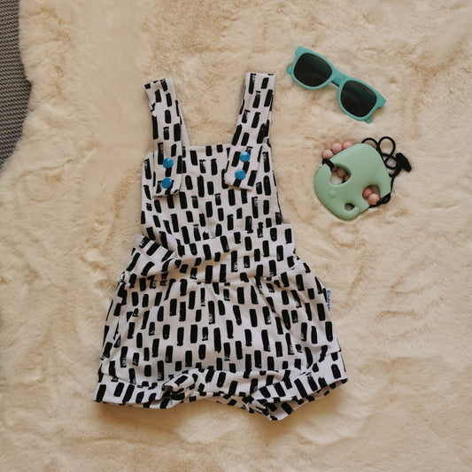Light and airy girls cross strap dungaree shorts, with shoulder popper entry. Handmade using monochrome abstract stripes cotton jersey.
