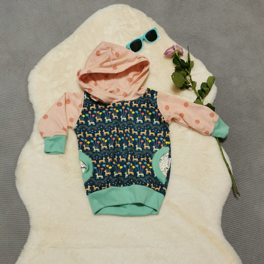 The fun and colourful unicorns and spots girls hooded tunic. Handmade using navy unicorns, white unicorns and pink spots organic cotton jerseys', with mint cotton ribbing.