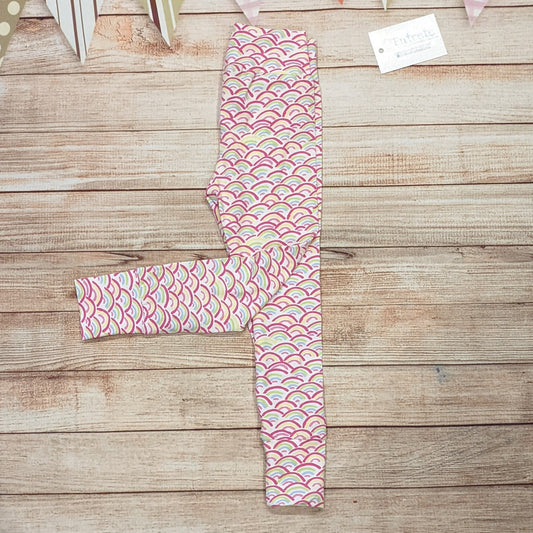 The adorable mini rainbows leggings, handmade using mini rainbows on white cotton jersey. Shown folded.