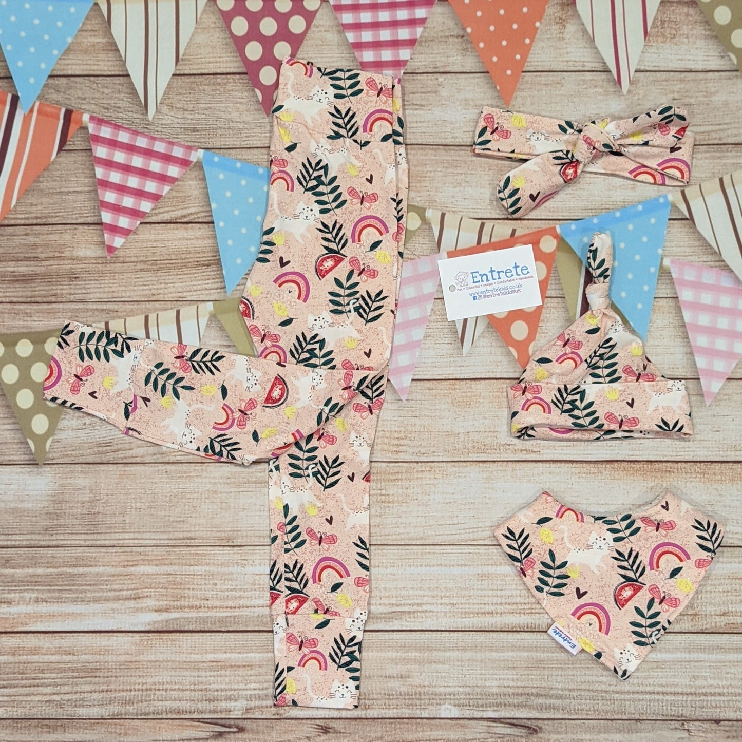 Playful pink cats girls leggings, handmade using pink cats cotton jersey. Shown with matching headband, tie top hat and bamboo bib.