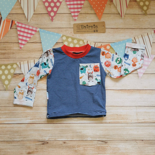 Front view of the fun and colourful monsters & navy striped long sleeve t-shirt. Handmade using pale blue organic monsters cotton jersey on navy striped cotton jersey. With red cotton ribbing neck.
