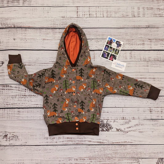 The sumptuously soft forest foxes popper hoodie. Handmade using forest foxes alpine fleece, chocolate cotton ribbing and orange cotton jersey.