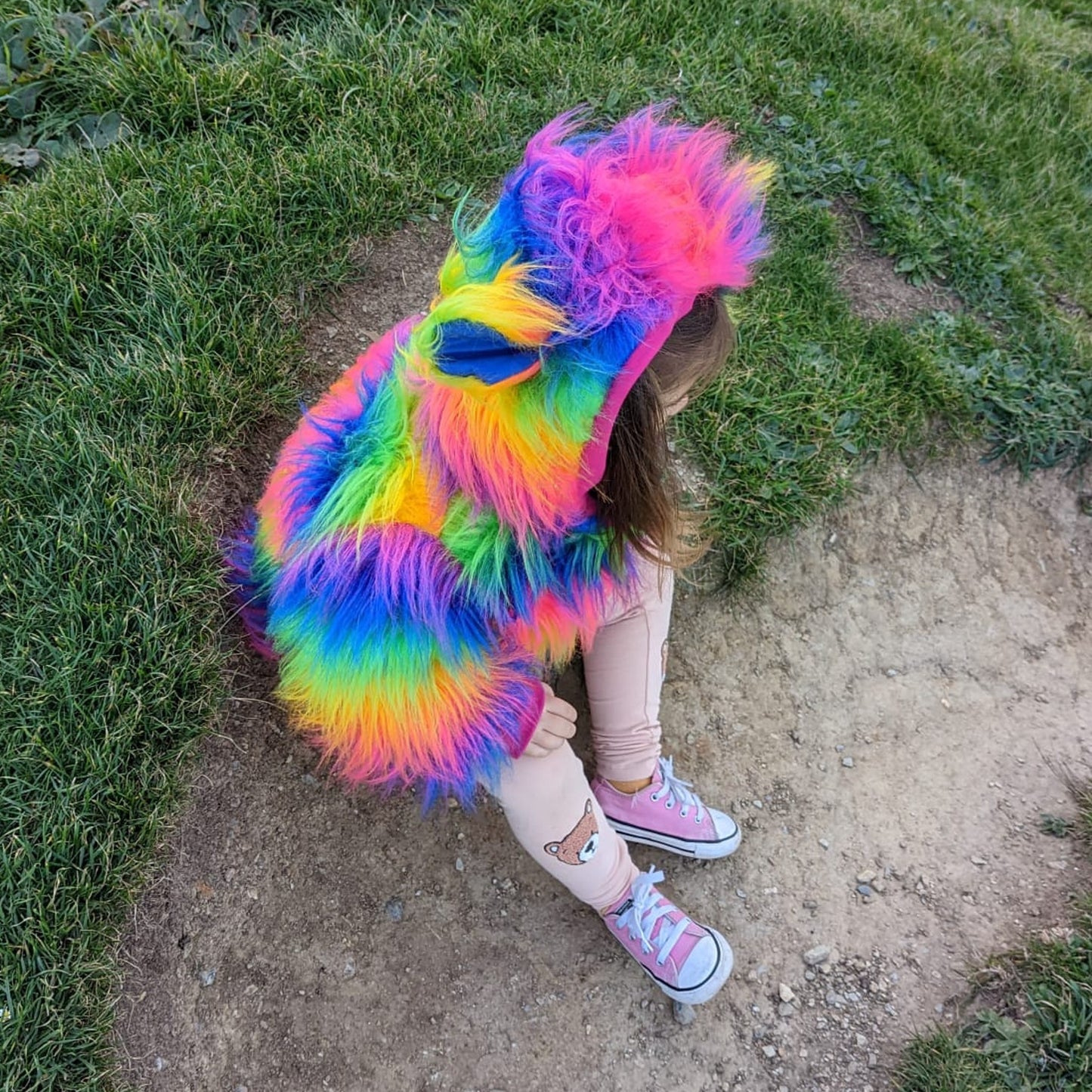 Sophie snug and warm in her reversible rainbow bear hoodie. Vibrant and loads of fun.