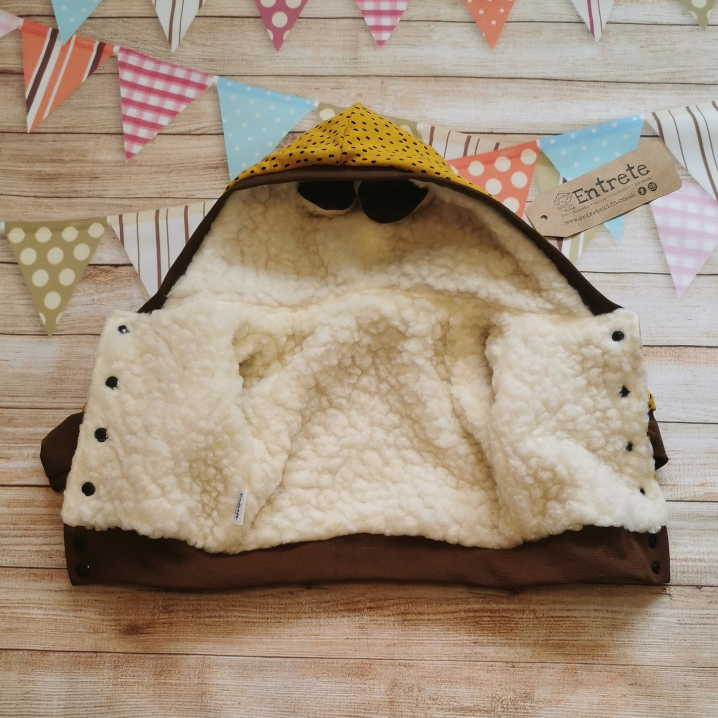 Open view of the sheep hoodie. Showing the easy popper entry and warm sherpa fur.