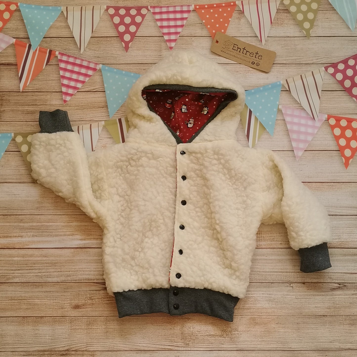 The festive and fun red christmas penguins hoodie, with warm sherpa fur. Showing the Sherpa fur reverse side.