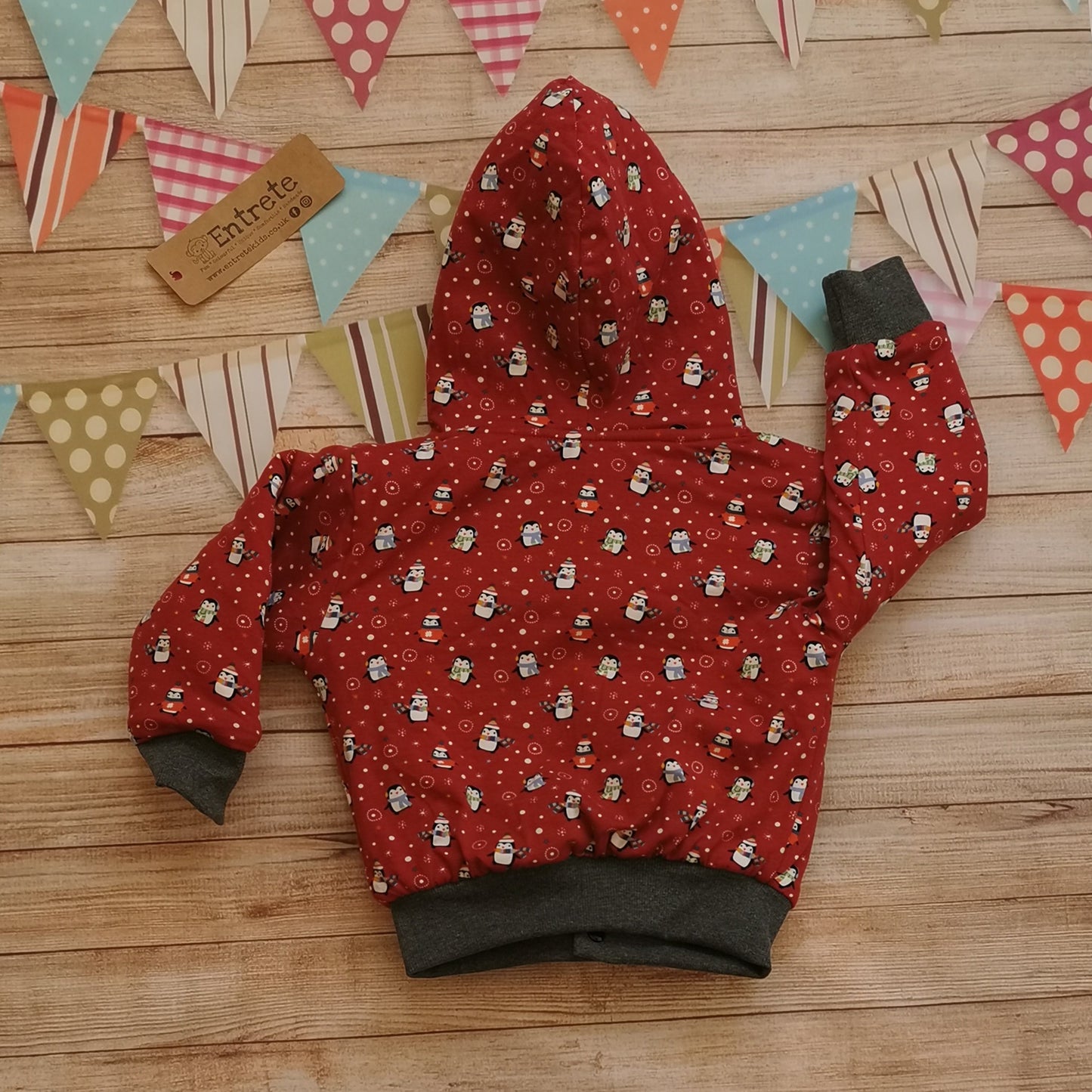 Rear of the festive and fun red christmas penguins hoodie, with warm sherpa fur.