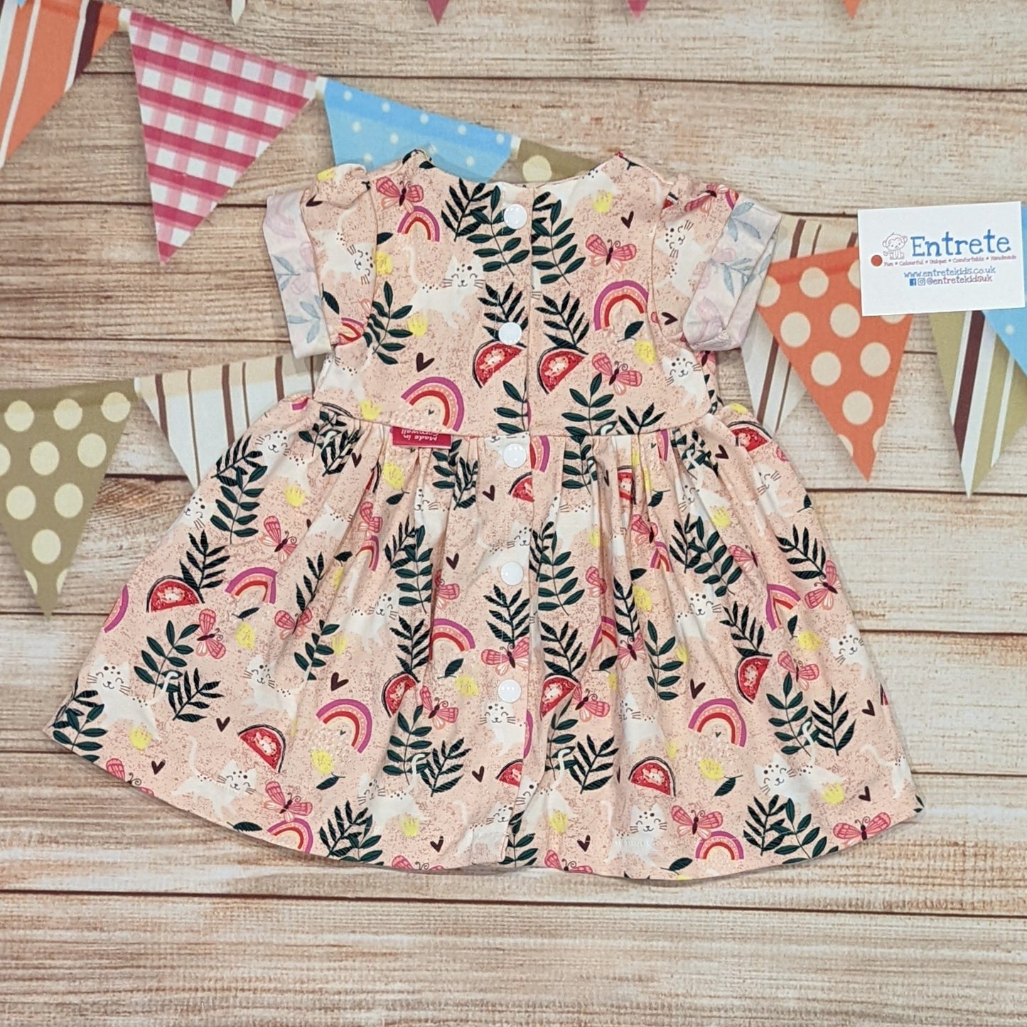 The playful pink cats girls dress, handmade using pink cats cotton jersey. Short sleeve version shown from the rear.