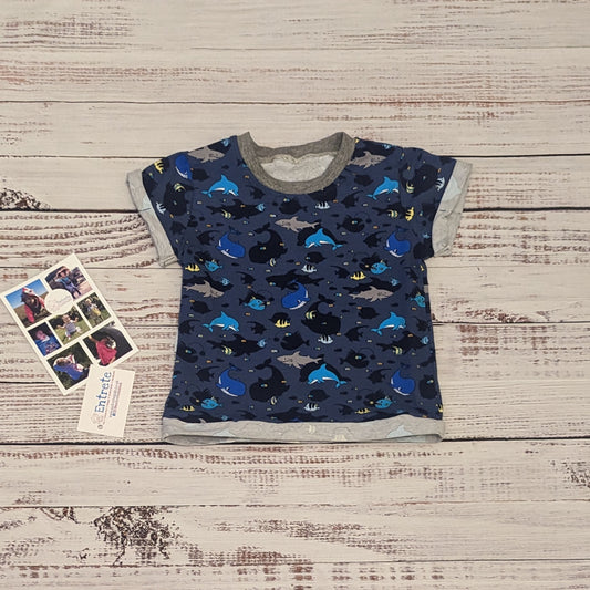 The short sleeved navy sea life shadows T-shirt. Handmade using navy sea life shadows cotton jersey and grey cotton ribbing.