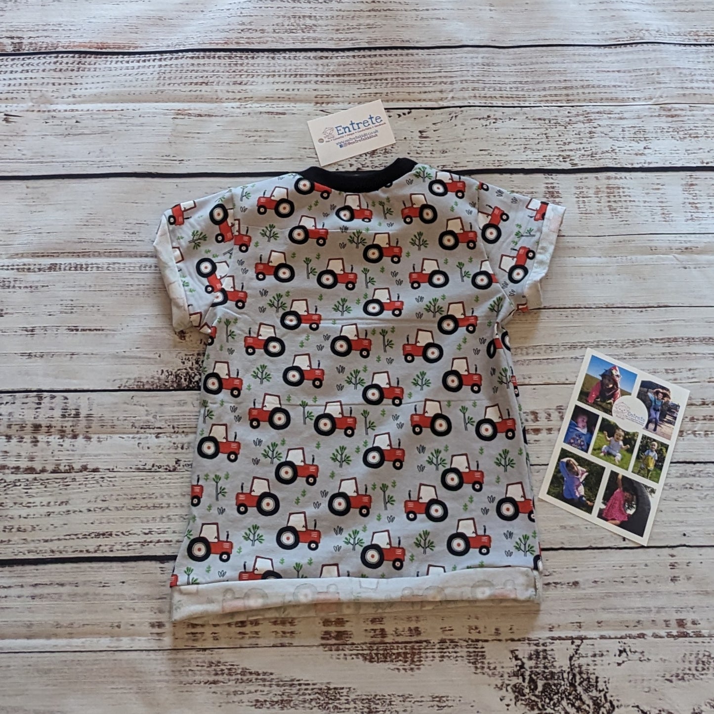 Farming fun with this red tractors on grey T-shirt, with it's contrasting front pocket. Handmade using grey tractors and black cotton jerseys' and black cotton ribbing. Shown from the rear.