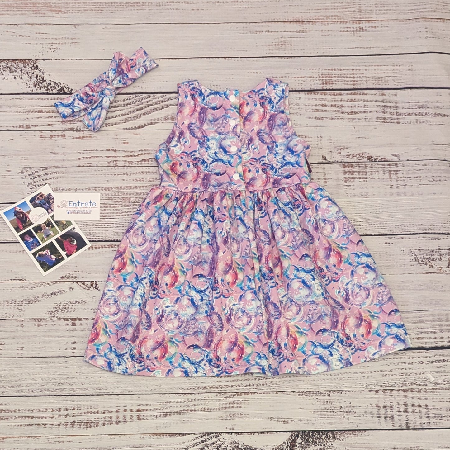 Gourgouse girls sleeveless bubblegum dress. Handmade using bubblegum pink bubbles cotton jersey. Shown from the rear with a headband available separately.