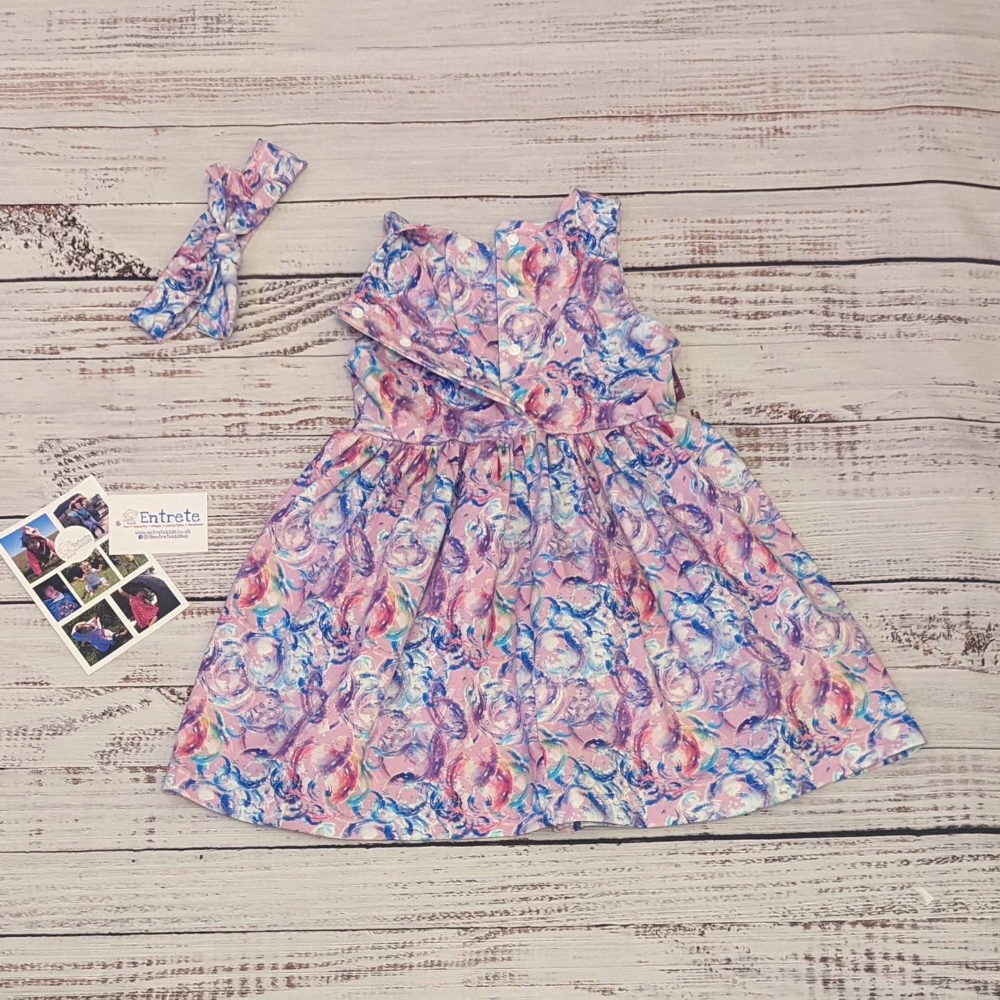 Gourgouse girls sleeveless bubblegum dress. Handmade using bubblegum pink bubbles cotton jersey. Showing the popper entry system open..