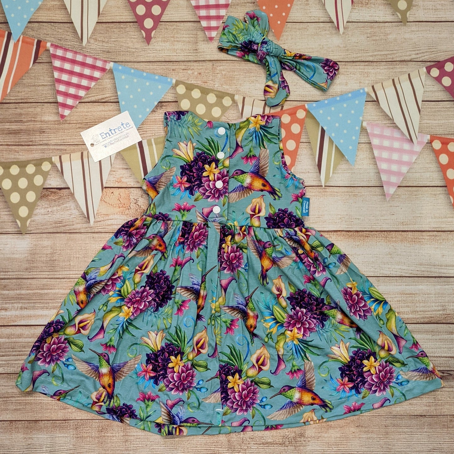 Beautiful green hummingbirds girls dress, handmade using green hummingbirds viscose jersey. Sleeveless version shown from the rear with a matching headband..