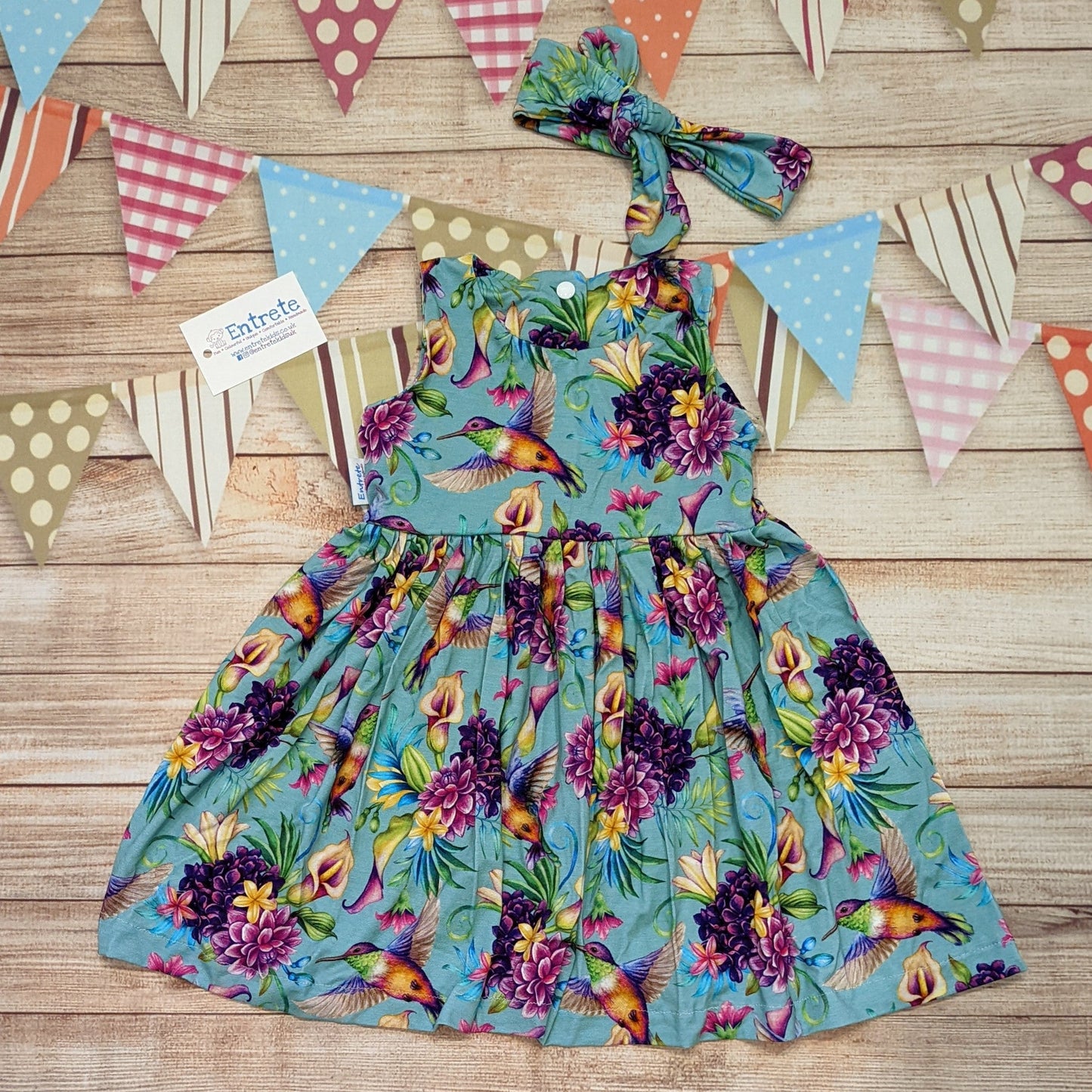 Beautiful green hummingbirds girls dress, handmade using green hummingbirds viscose jersey. Sleeveless version shown with a matching headband..