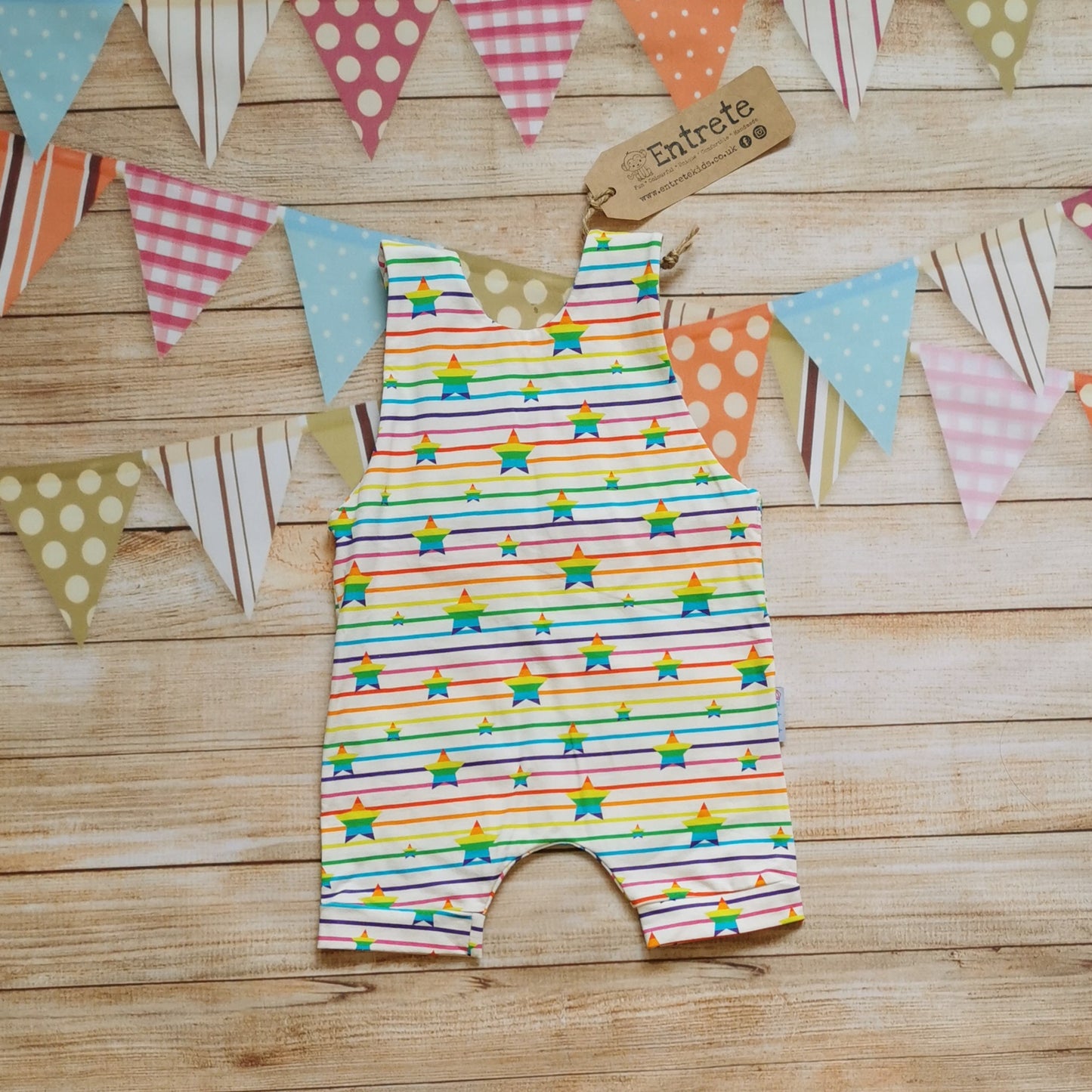 Rear of Unisex kids romper shorts, handmade using stunning rainbow stars cotton jersey.