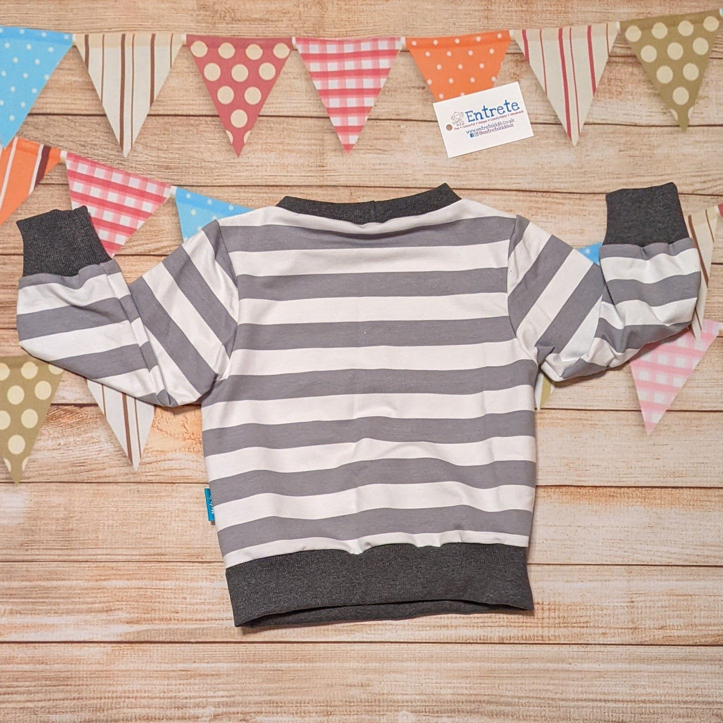 Grey and white striped sweatshirt. Handmade using grey striped cotton French terry and graphite cotton ribbing. Shown from the rear.