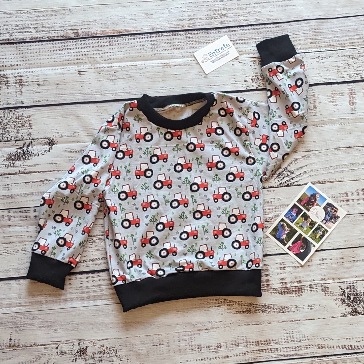 The lightweight red tractors on grey kids sweatshirt. Handmade using grey tractors cotton jersey and black cotton ribbing.