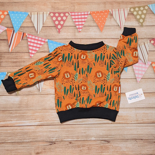 The ferocious lions sweatshirt, handmade using orange lions cotton French terry and black cotton ribbing.