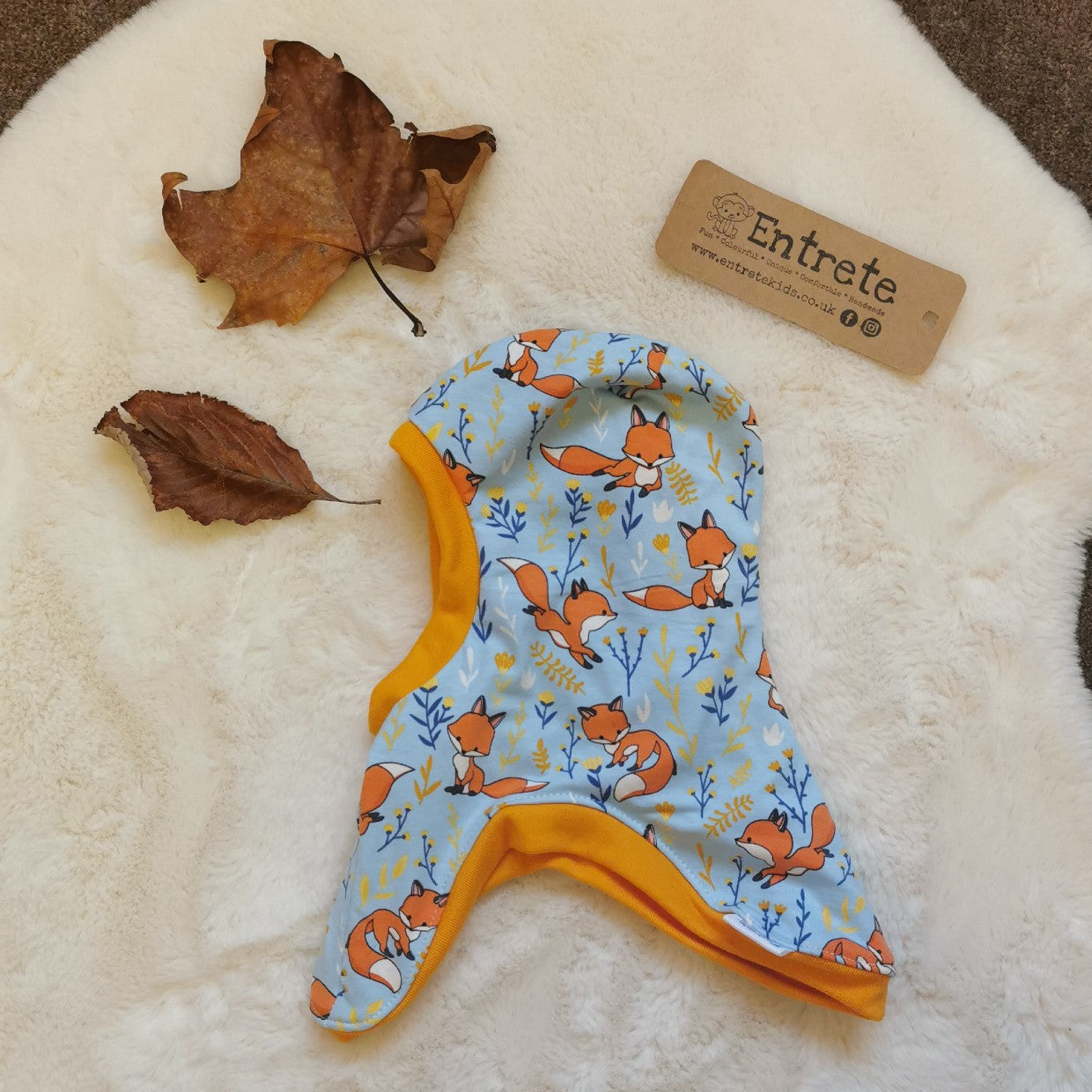 Soft and stretchy kids balaclava handmade using sky blue foxes cotton jersey, yellow ribbing and yellow cotton jersey lining. Side view.