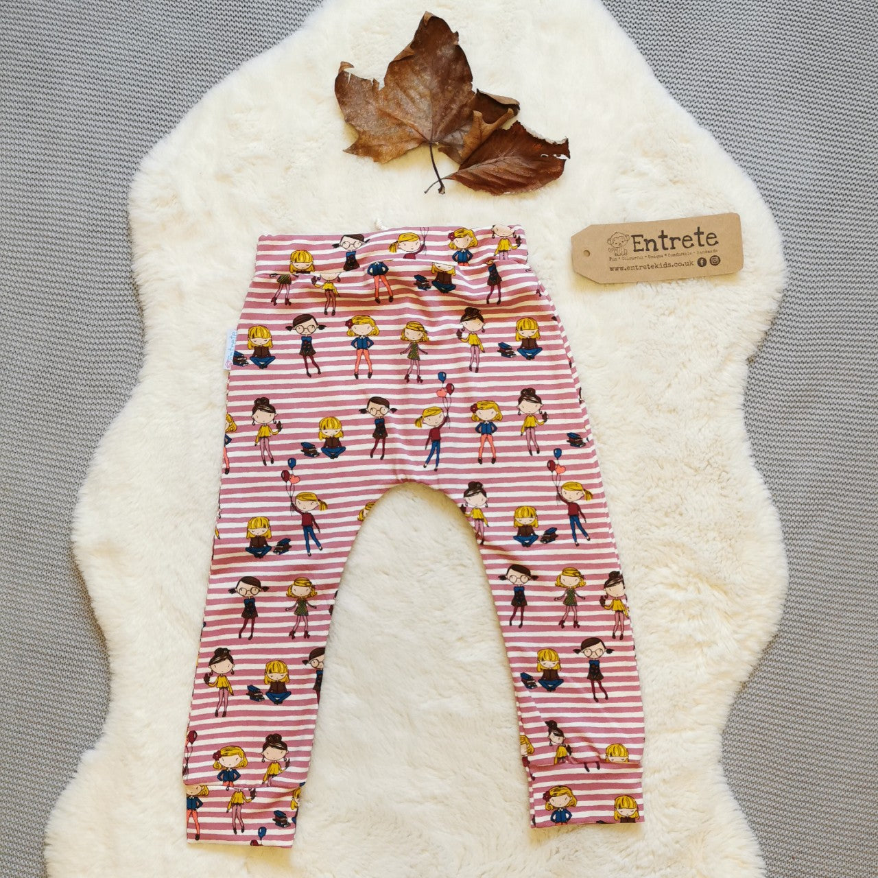 Rear view of harem joggers with elasticated waist, dropped crotch and roll-able ankle cuffs. Handmade in pretty girls on pink stripes cotton jersey.