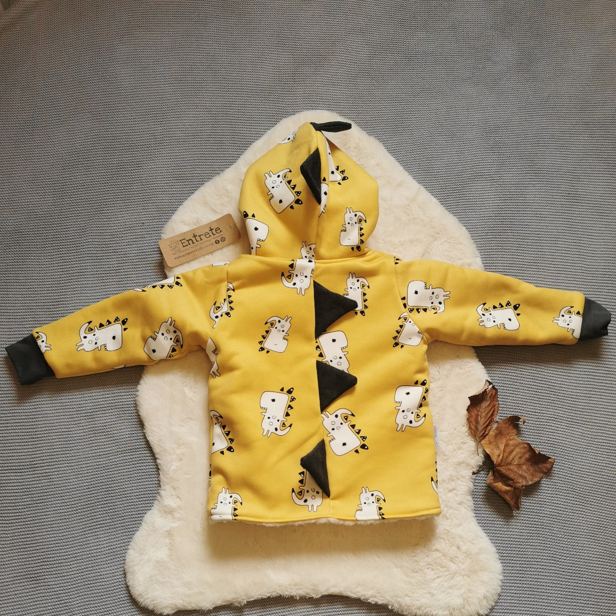 Rear View of the epic Mustard Dinosaur coat. Handmade using mustard dinosaur alpine sweatshirt fleece, black cotton jersey and graphite cotton ribbing.
