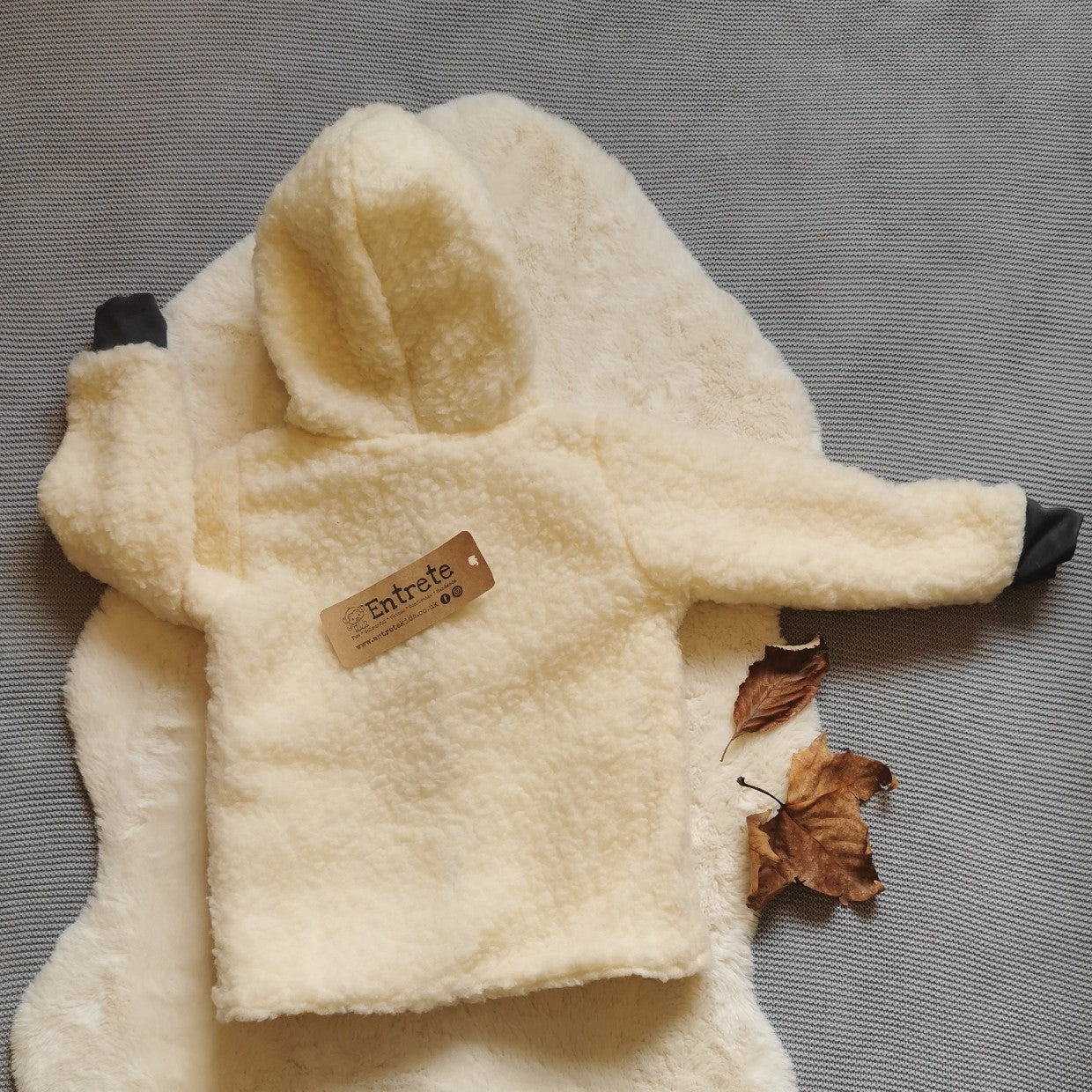 Rear of the reverse side of the epic mustard dinosaur coat. Handmade in stylish and warm sherpa fur with graphite cotton ribbing.