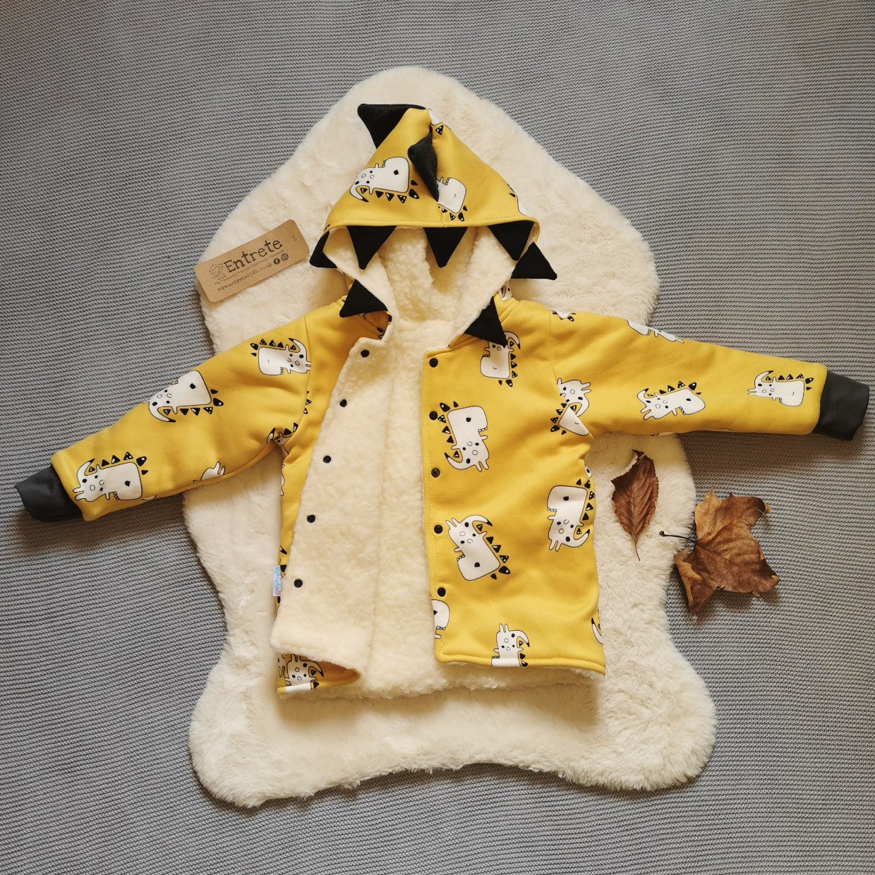 Open View of the epic Mustard Dinosaur coat, showing the sherpa fur inner. Handmade using mustard dinosaur alpine sweatshirt fleece, black cotton jersey and graphite cotton ribbing.