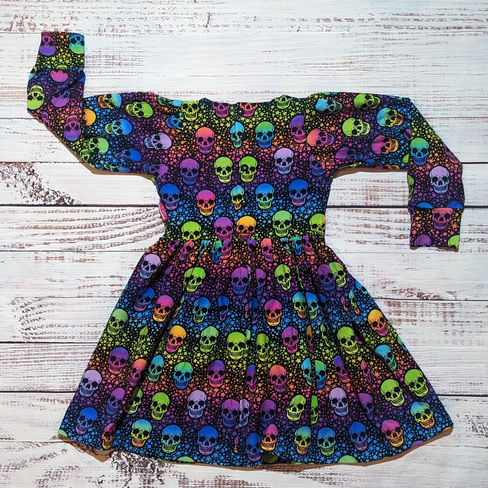 The vivid colourful neon skulls back popper dress. Handmade from soft and comfy cotton jersey. Shown from the rear.