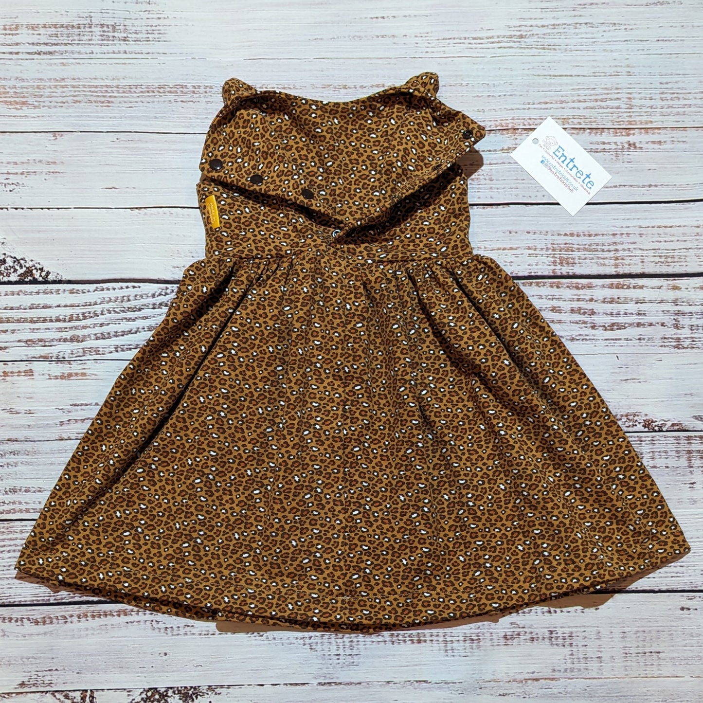 The cool camel leopard print girls dress. Handmade using soft and comfy organic cotton jersey. Shown with the back popper entry open.