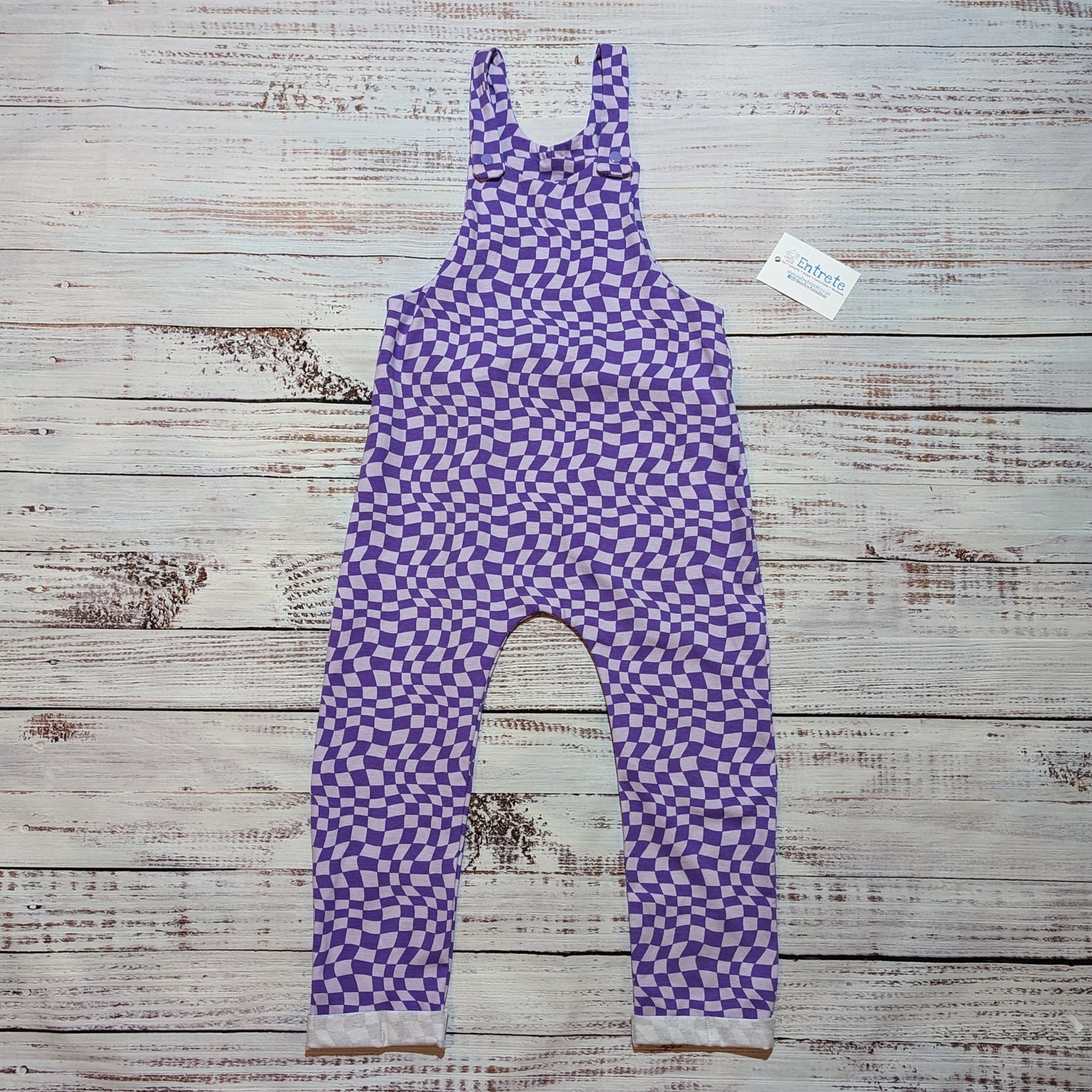 Kid's dungarees in a warped purple trippy checked print. Handmade in soft, stretchy and comfortable cotton jersey.