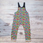 Colourful child and toddler dungarees. Handmade using soft and comfortable rainbow leopard print cotton jersey. With popper Shoulder straps. Shown from the rear.