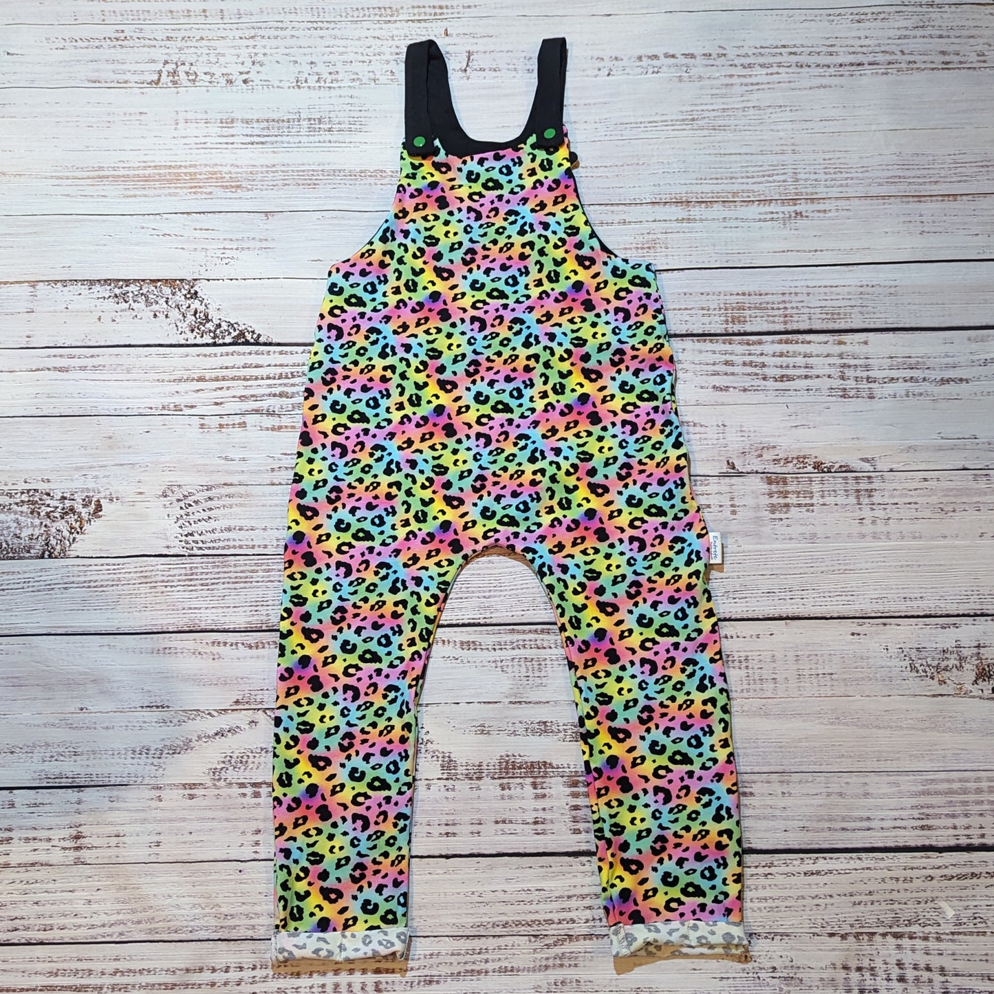 Colourful child and toddler dungarees. Handmade using soft and comfortable rainbow leopard print cotton jersey. With popper Shoulder straps.