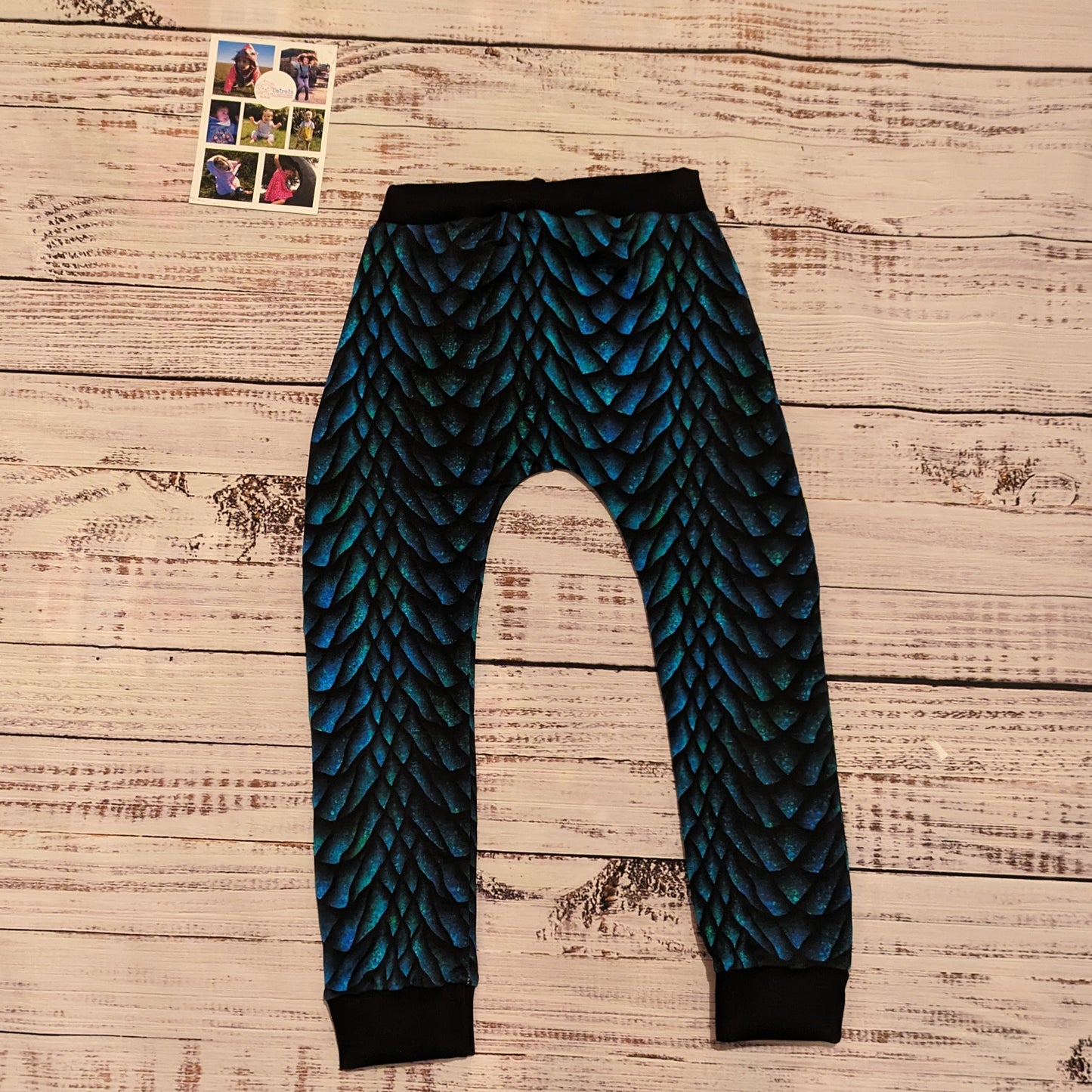 The gorgeously glimmering dragon scales harem joggers. Handmade using dragon scales cotton French terry and black cotton ribbing. Shown from the rear.