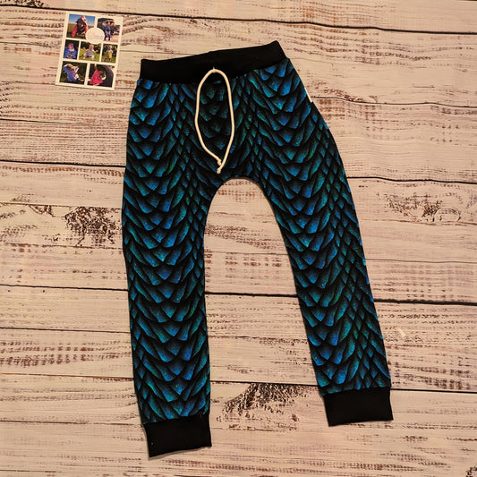 The gorgeously glimmering dragon scales harem joggers. Handmade using dragon scales cotton French terry and black cotton ribbing.