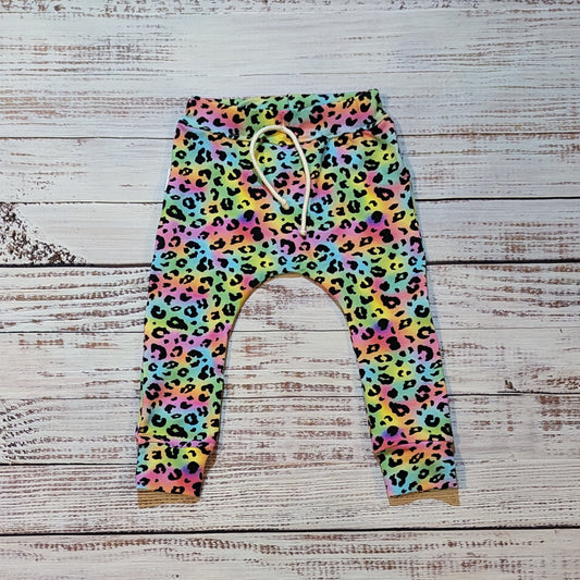 Child and toddler colourful animal print harem joggers. Lovingly handmade using soft and comfortable rainbow leopard print cotton jersey.